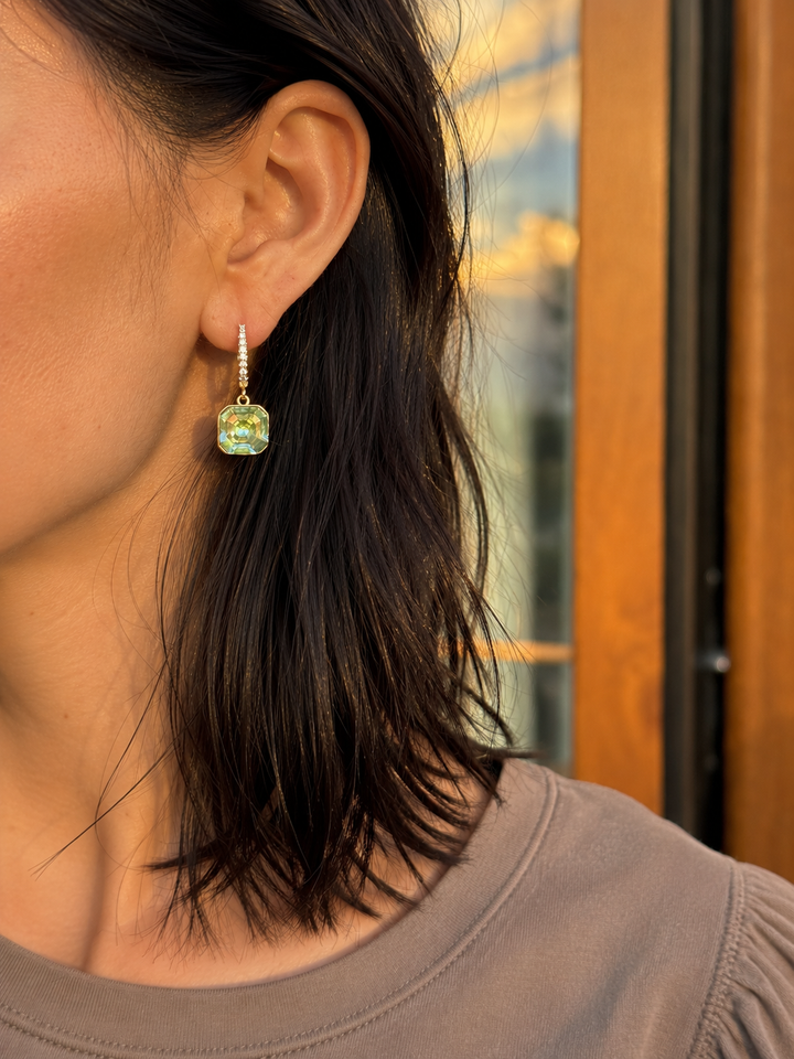 Mirdzoši Green Crystal auskari ar zaļu kristālu elegantā portreta fotosesijā.